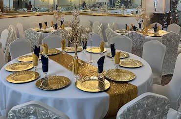 green and white themed banquet hall with tables set up